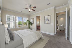 San Antonio apartment for rent - A bedroom with a large bed and a ceiling fan.