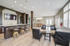 Columbus apartment for rent - A modern living room with a bar area and a fireplace.