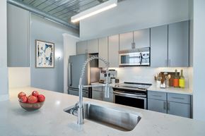 Atlanta apartment for rent - A modern kitchen with a stainless steel sink and refrigerator.