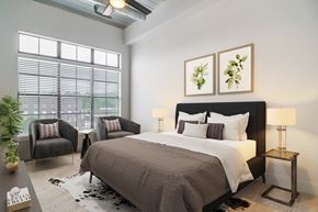 Atlanta apartment for rent - A bedroom with a large bed and two chairs.