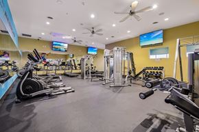 Denver apartment for rent - A gym with a variety of equipment including treadmills, weights, and exercise machines.