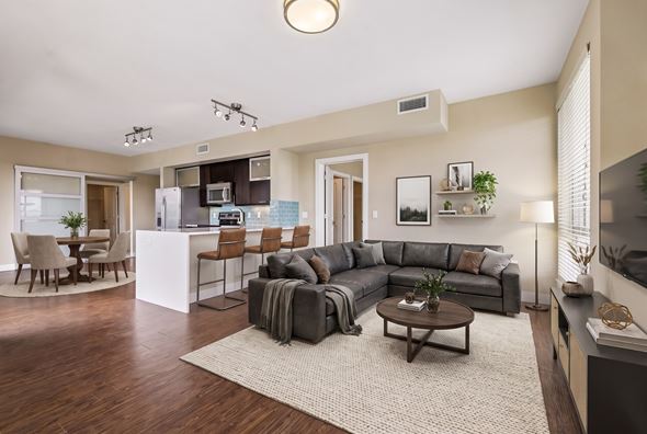 Denver apartment for rent - A modern living room with a grey sofa set and a wooden coffee table.