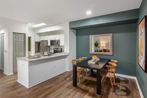 Miramar apartment for rent - A kitchen with a breakfast bar and a dining table with chairs.