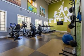 Charlotte apartment for rent - A gym with a green wall that says Fitness.