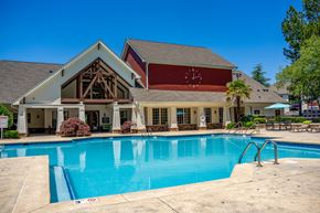 Charlotte apartment for rent - A large house with a pool in front.