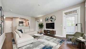 Fishers apartment for rent - A living room with a white couch and a coffee table.