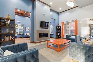 Louisville apartment for rent - A living room with a blue couch and an orange coffee table.