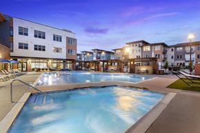 Denver apartment for rent - A large outdoor swimming pool surrounded by apartment buildings.