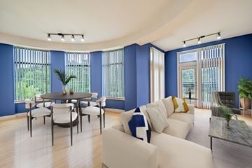 Durham apartment for rent - A living room with a white couch and a dining table.