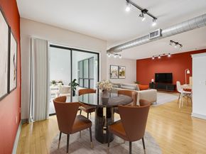 Durham apartment for rent - A modern dining room with a glass table surrounded by brown chairs.