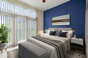 Durham apartment for rent - A bedroom with a large bed and a plant by the window.