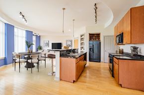 Durham apartment for rent - A kitchen with wooden cabinets and a dining table with chairs.