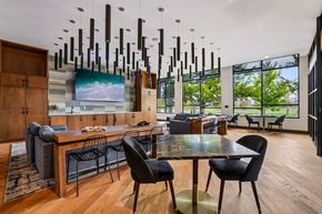 Littleton apartment for rent - A modern dining room with a long table and chairs.