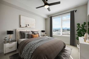 Littleton apartment for rent - A bedroom with a large bed and a ceiling fan.