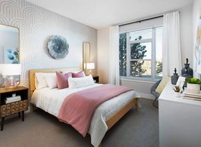 Littleton apartment for rent - A bedroom with a large bed and a window with blinds.