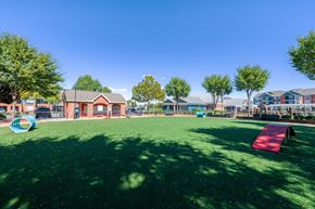 Louisville apartment for rent - A playground with a red slide and a blue ball pit.