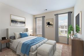 Louisville apartment for rent - A bedroom with a large bed and a window with blinds.