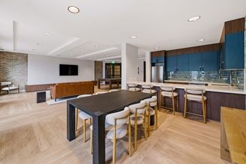 Santa Rosa apartment for rent - A modern kitchen with a long black table and white chairs.