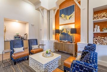 Plymouth apartment for rent - A living room with a white coffee table and blue chairs.