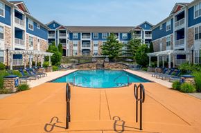 Mason apartment for rent - A swimming pool in front of apartment buildings.