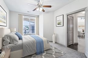 San Antonio apartment for rent - A bedroom with a large bed and a ceiling fan.