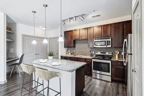 San Antonio apartment for rent - A modern kitchen with a dining table and chairs.