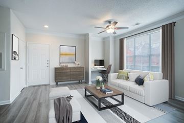 Huntersville apartment for rent - A modern living room with a white couch and a wooden coffee table.