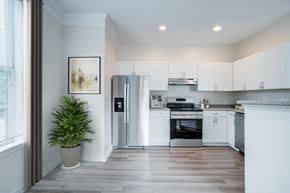 Huntersville apartment for rent - A modern kitchen with white cabinets and stainless steel appliances.