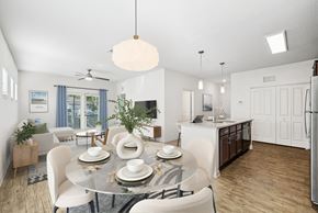 Largo apartment for rent - A modern dining room with a glass table and white chairs.