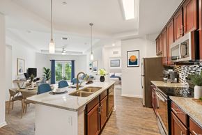 Largo apartment for rent - A kitchen with a white counter top and wooden cabinets.