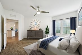Largo apartment for rent - A bedroom with a bed, dresser, and ceiling fan.