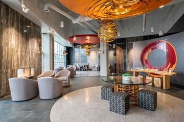 Indianapolis apartment for rent - A modern living room with a glass table and a fireplace.