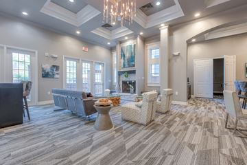 Cary apartment for rent - A living room with a grey carpet and a chandelier.