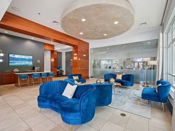 Durham apartment for rent - A living room with blue chairs and a blue couch.