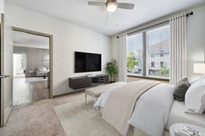 Prospect apartment for rent - A bedroom with a large bed and a flat screen TV mounted on the wall.
