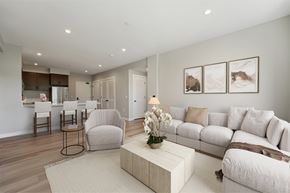 Santa Rosa apartment for rent - A living room with a white couch, a coffee table, and a dining area in the background.