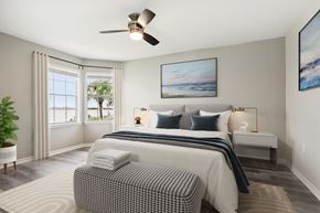 Clearwater apartment for rent - A bedroom with a large bed and a ceiling fan.