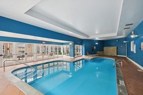 Woodbury apartment for rent - A large indoor swimming pool with a blue tiled wall.