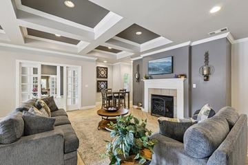 Murfreesboro apartment for rent - A living room with grey couches and a fireplace.