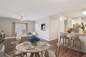 Murfreesboro apartment for rent - A dining room with a table set for two and a vase of flowers.
