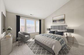 Columbus apartment for rent - A bedroom with a large bed and a chair.