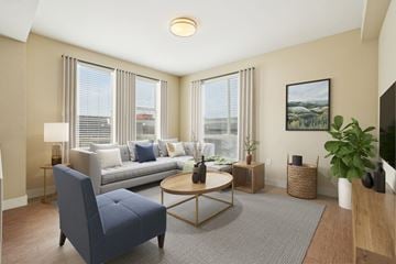 Denver apartment for rent - A living room with a blue chair and a grey sofa.