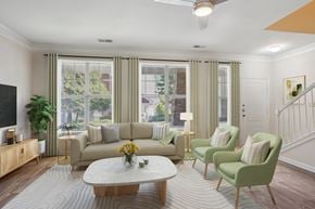 Charlotte apartment for rent - A living room with a sofa, two chairs, a coffee table, and a television.
