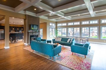 Louisville apartment for rent - A living room with a blue couch and a rug.