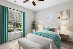 Mason apartment for rent - A bedroom with a large bed and a ceiling fan.