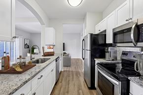 Mason apartment for rent - A kitchen with white cabinets and stainless steel appliances.