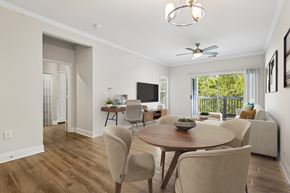 Mason apartment for rent - A well-lit dining room with a wooden table and chairs.