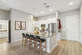 Scottsdale apartment for rent - A kitchen with a long island and chairs.