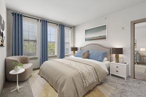 Franklin apartment for rent - A bedroom with a large bed, a chair, and a painting on the wall.