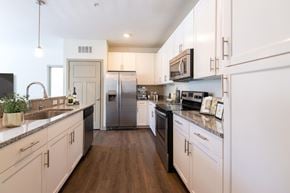 Prospect apartment for rent - A modern kitchen with white cabinets and stainless steel appliances.